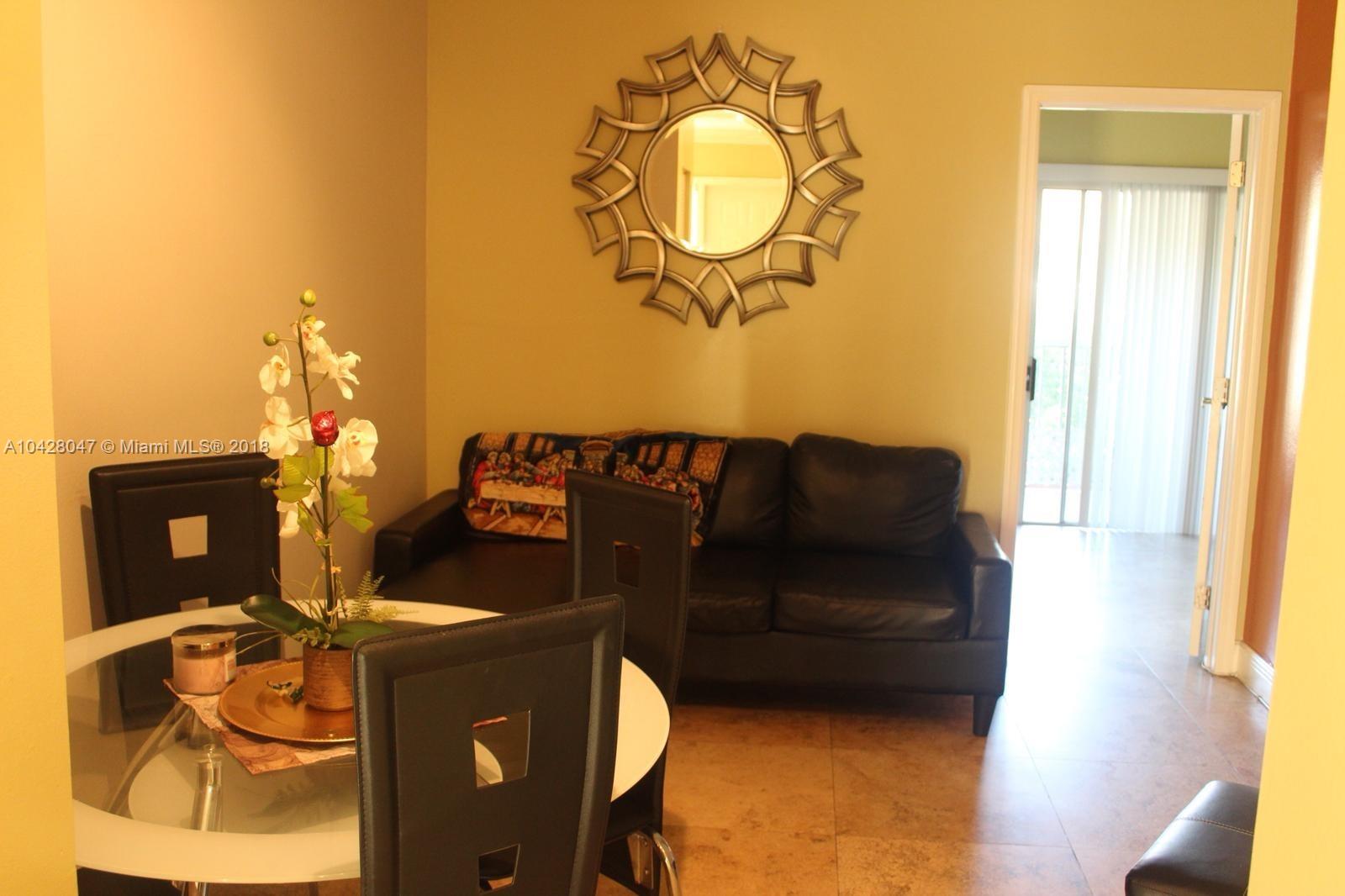 9511 Southwest 138th Place, Unit 9511 Miami, FL 33186 - Photo 6 of 17 a front view of a house with seating space