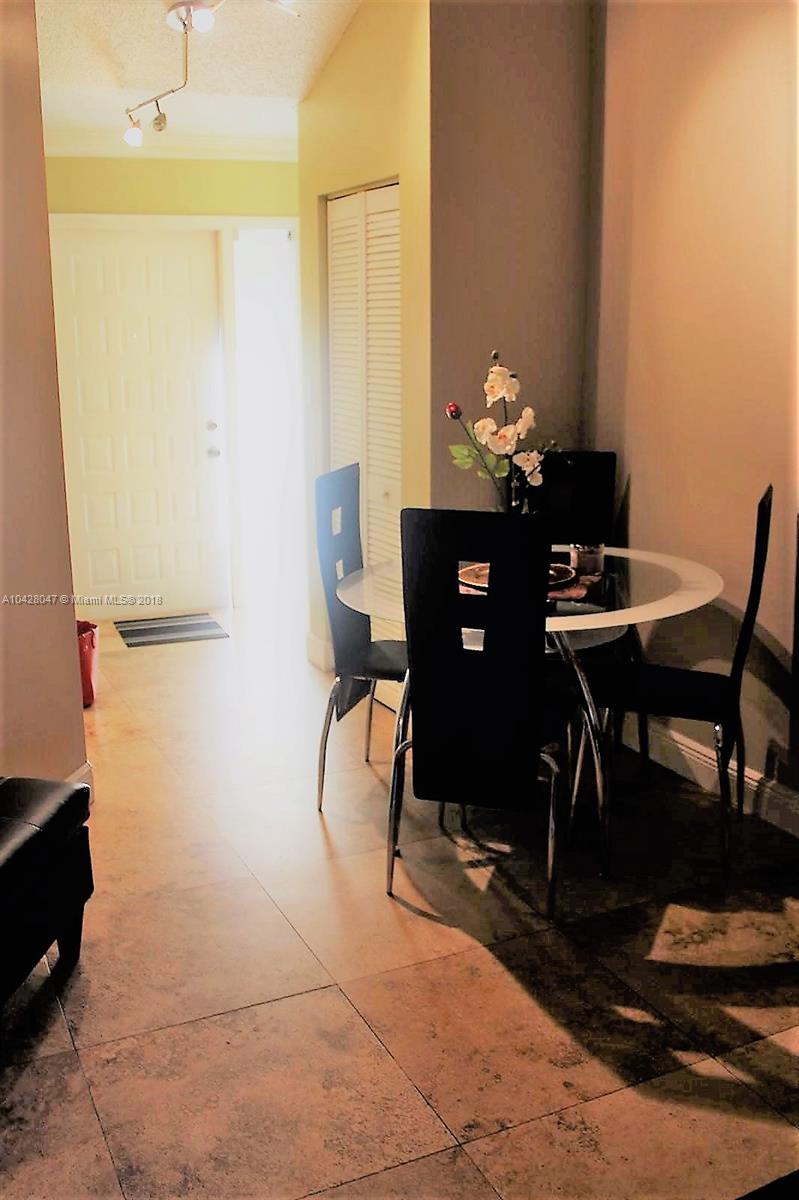 9511 Southwest 138th Place, Unit 9511 Miami, FL 33186 - Photo 7 of 17 a view of a workspace with furniture