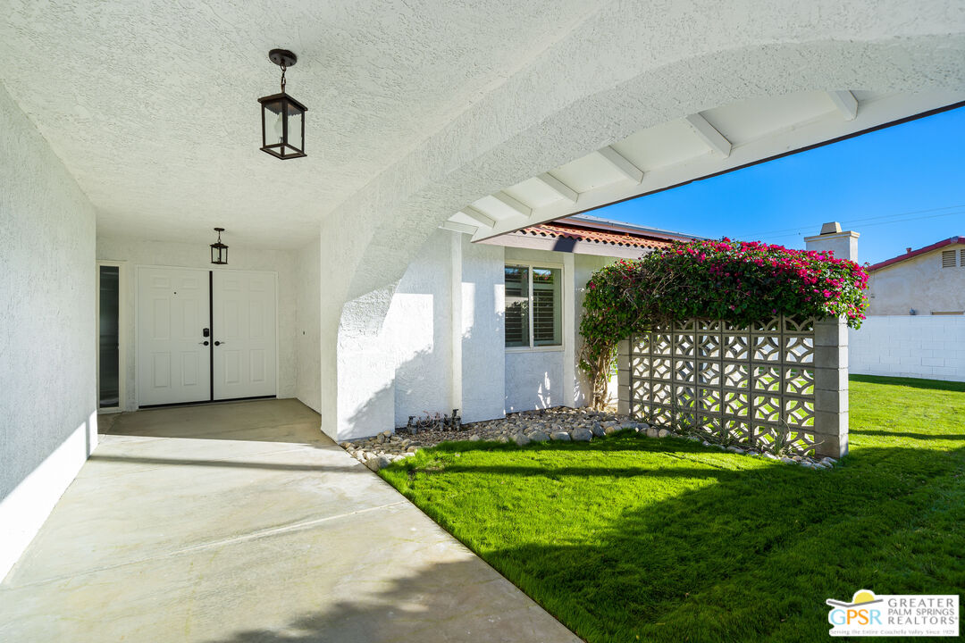 2750 East Vincentia Road Palm Springs, CA 92262 - Photo 15 of 55 a front view of a house with a yard and garage