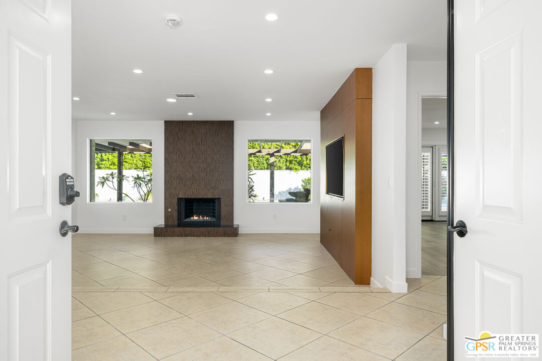 2750 East Vincentia Road Palm Springs, CA 92262 - Photo 18 of 55 a view of a hallway with a fireplace and a window