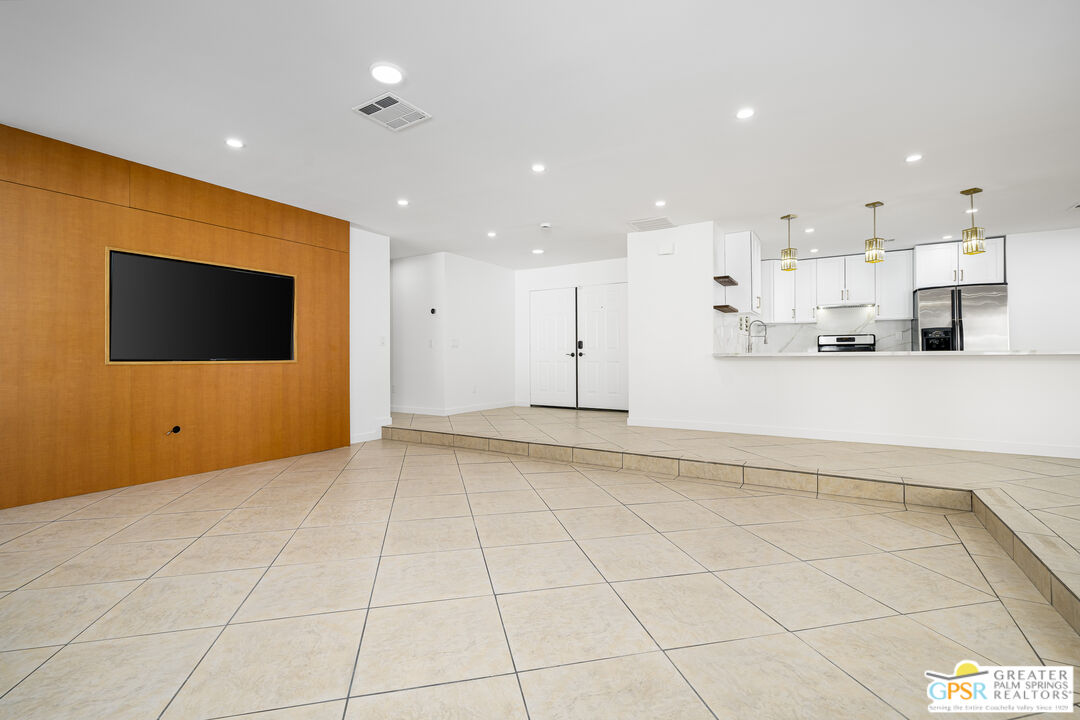 2750 East Vincentia Road Palm Springs, CA 92262 - Photo 23 of 55 a view of a kitchen with kitchen island white cabinets and stainless steel appliances