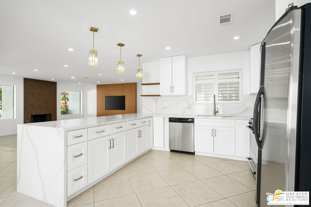 2750 East Vincentia Road Palm Springs, CA 92262 - Photo 26 of 55 a kitchen with white cabinets and white appliances