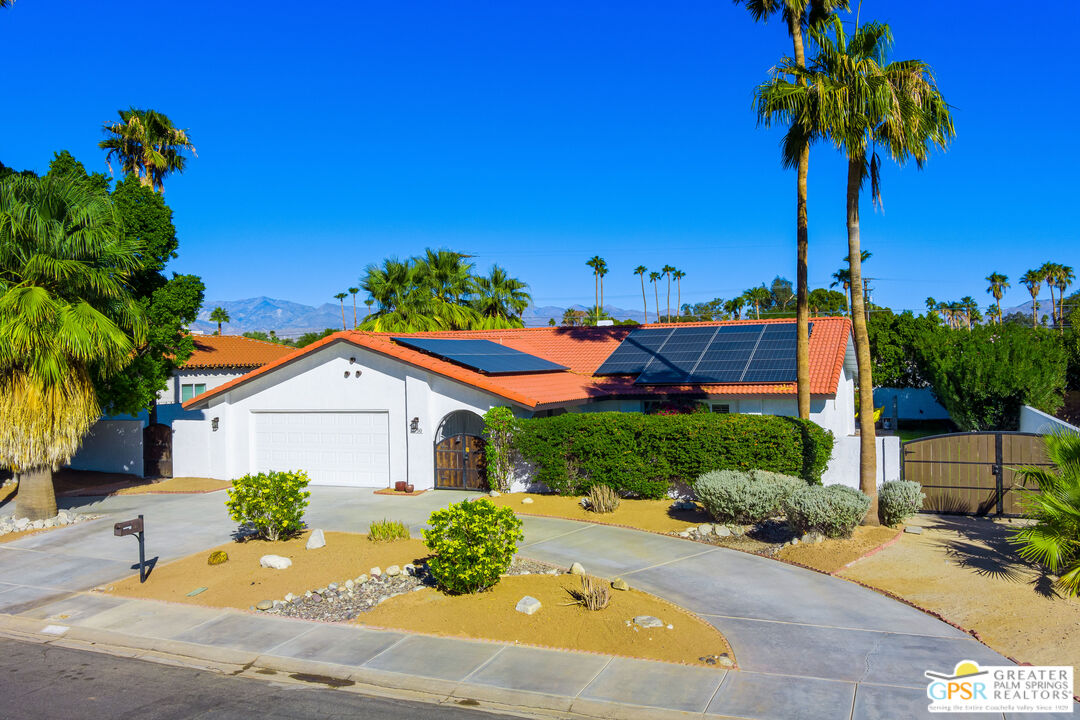2750 East Vincentia Road Palm Springs, CA 92262 - Photo 3 of 55 a front view of a house with a yard and potted plants