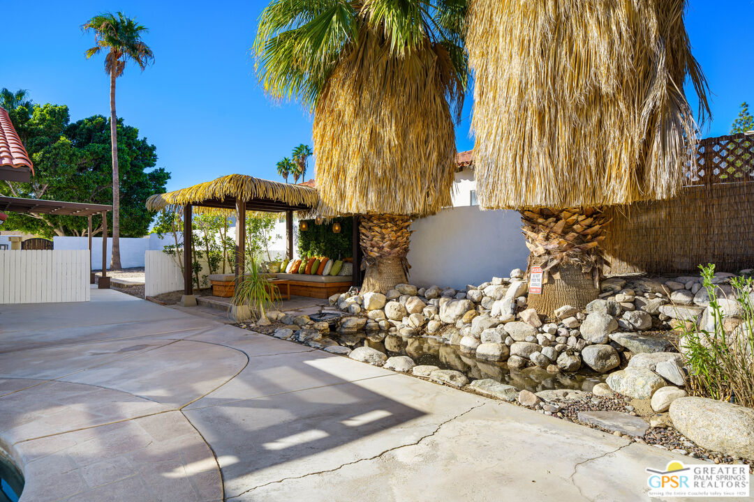 2750 East Vincentia Road Palm Springs, CA 92262 - Photo 33 of 55 a view of a patio with a table and chairs under an umbrella