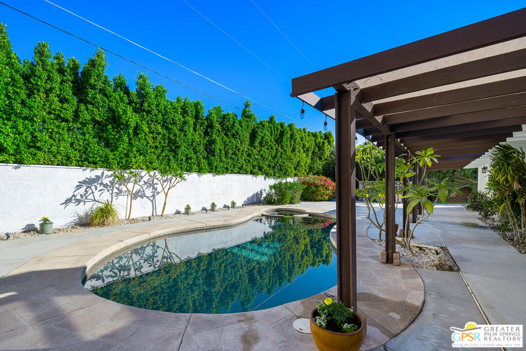 2750 East Vincentia Road Palm Springs, CA 92262 - Photo 36 of 55 a view of a patio with table and chairs potted plants with wooden floor