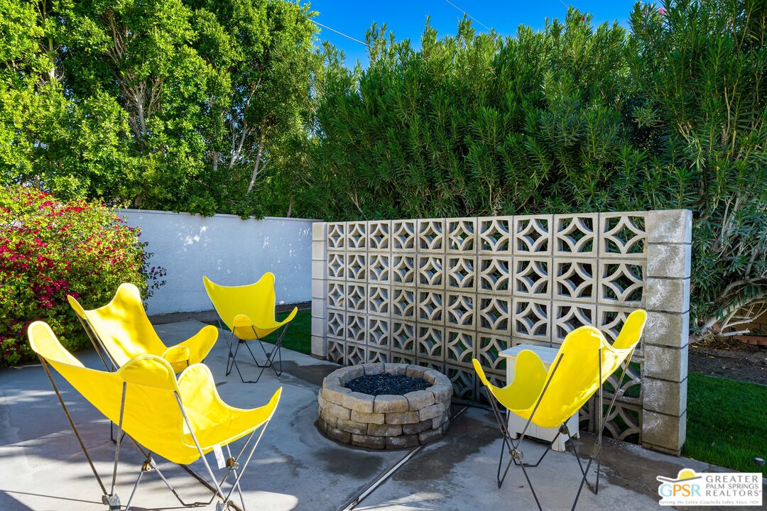 2750 East Vincentia Road Palm Springs, CA 92262 - Photo 43 of 55 a view of a swimming pool with a chairs and plants