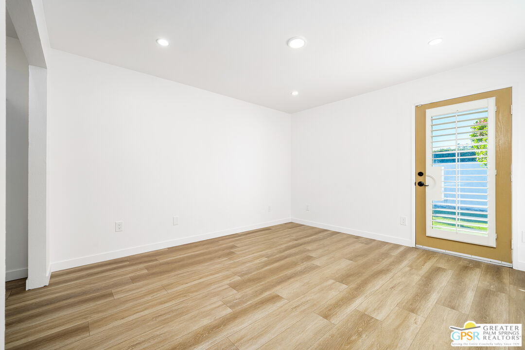 2750 East Vincentia Road Palm Springs, CA 92262 - Photo 51 of 55 a view of an empty room with wooden floor and a window