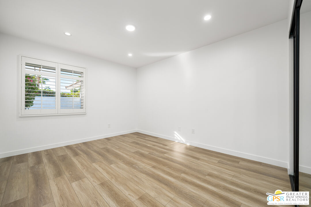 2750 East Vincentia Road Palm Springs, CA 92262 - Photo 52 of 55 an empty room with wooden floor and windows