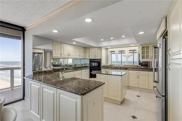 a bathroom with a granite countertop tub sink and mirror