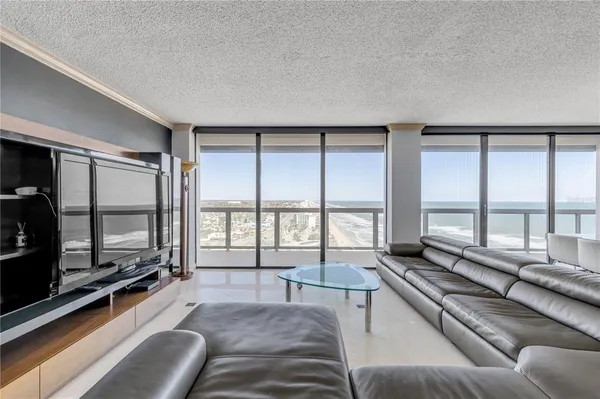 a living room with furniture rug and a large window