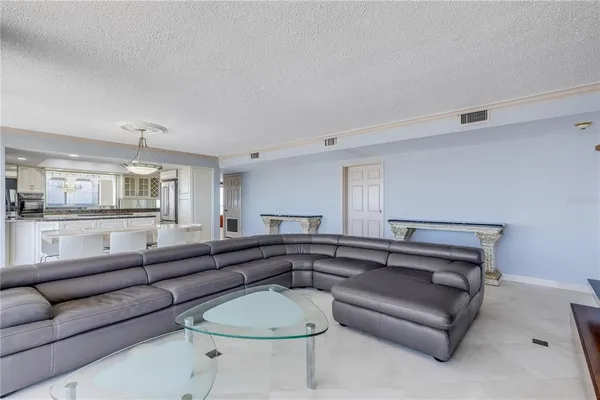 a spacious bedroom with a bed and a large window