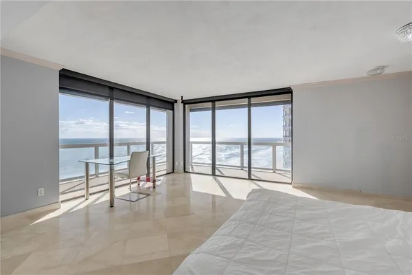a spacious bedroom with a large bed and a large window