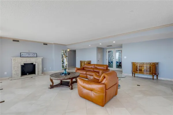 a living room with furniture a floor to ceiling window and a flat screen tv