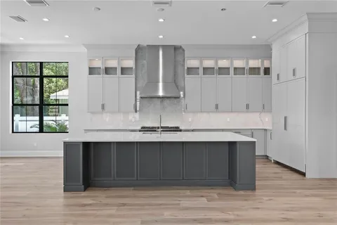 a kitchen with a sink cabinets and wooden floor