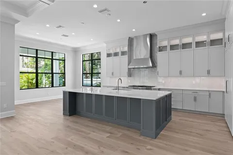 a large kitchen with stainless steel appliances granite countertop a stove and a sink