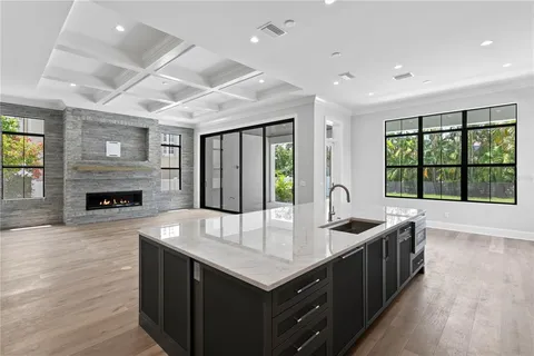 a kitchen with sink cabinets and wooden floor