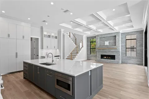 a kitchen with a stove and a wooden floor