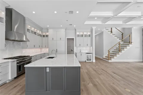 a kitchen with a sink stainless steel appliances and cabinets