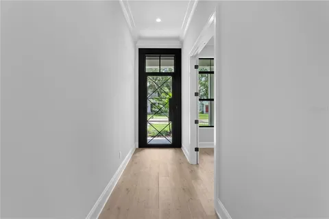 a view of hallway with wooden floor