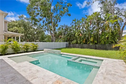 a swimming pool with outdoor seating and yard