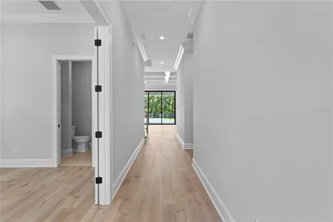 a view of hallway with wooden floor