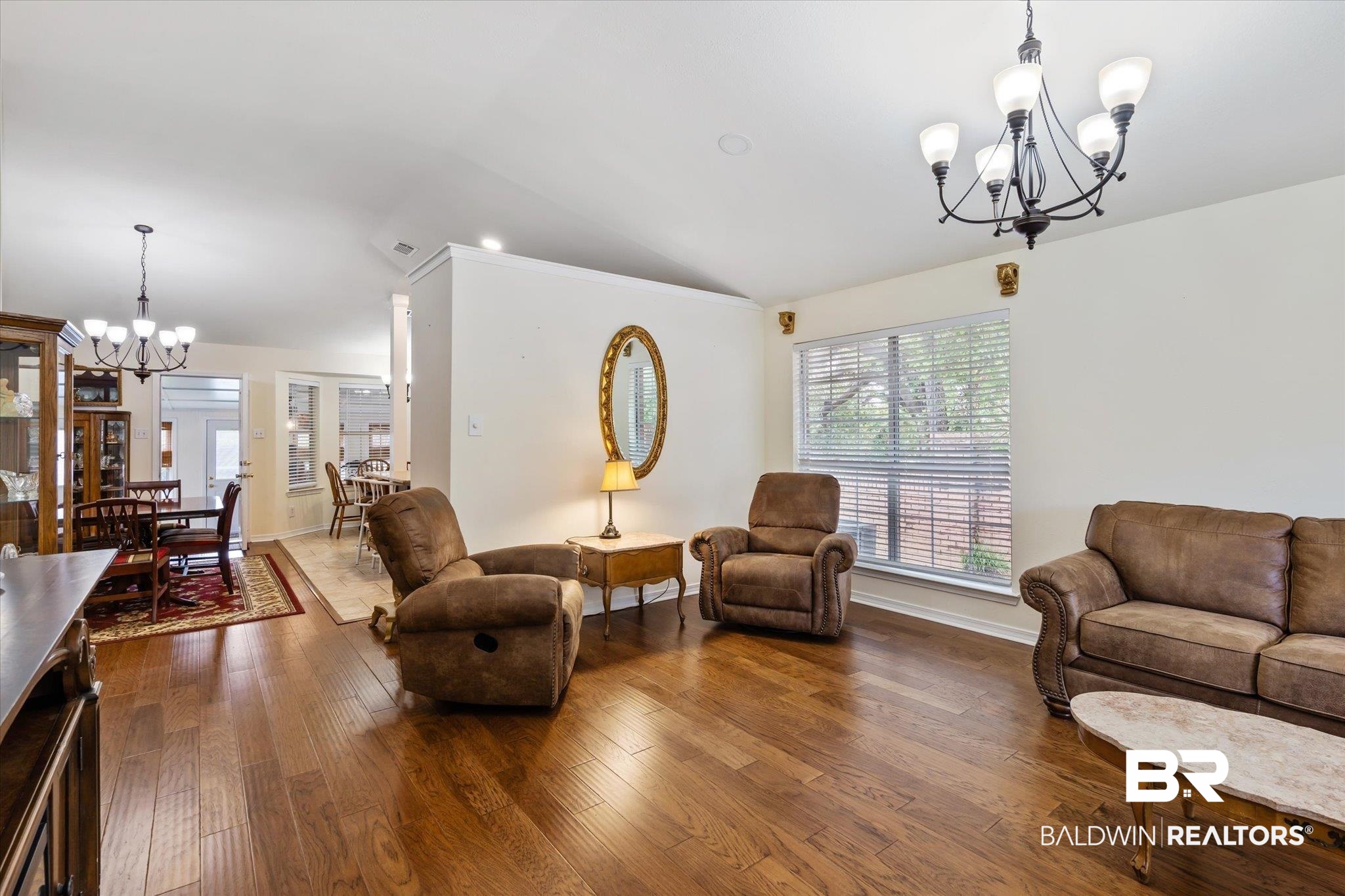 7236 Highpointe Place East Daphne, AL 36527 - Photo 3 of 32 Living room with lofted ceiling, dark wood-type flooring, and an inviting chandelier