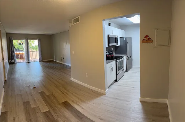 a view of a kitchen cabinets and wooden floor