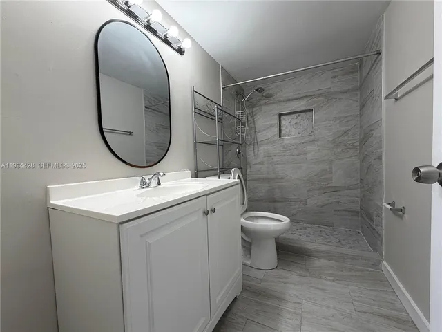 a bathroom with a toilet a sink and a mirror
