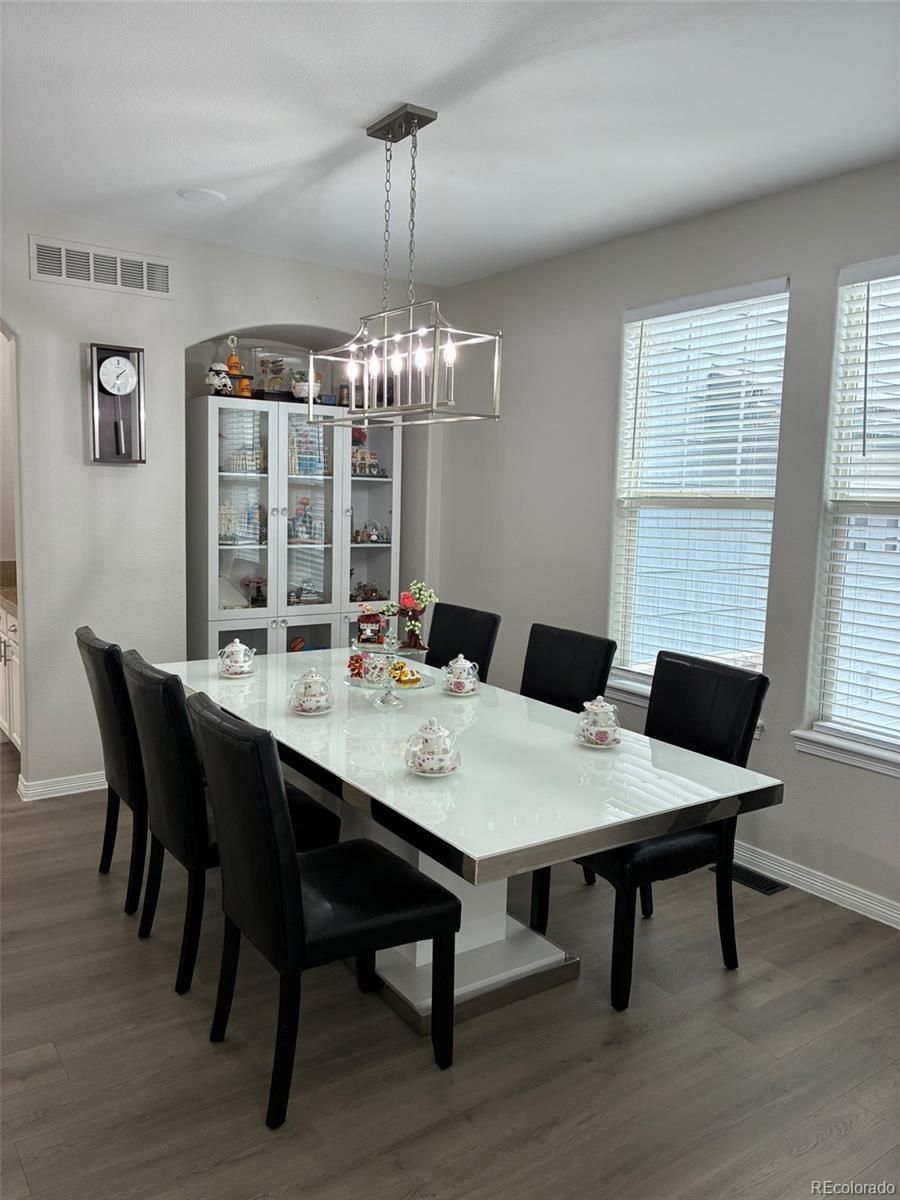 7242 South Rome Street Aurora, CO 80016 - Photo 13 of 33 a view of a dining room with a table and chairs