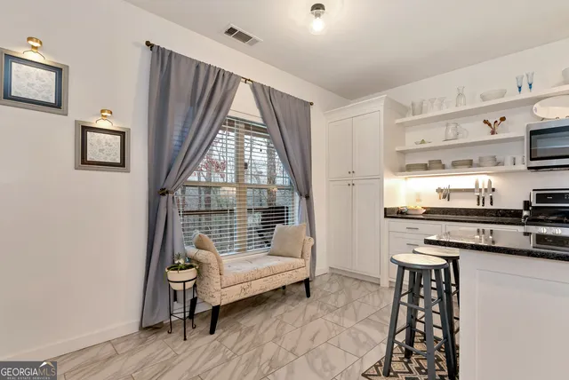 a view of a hallway with seating area