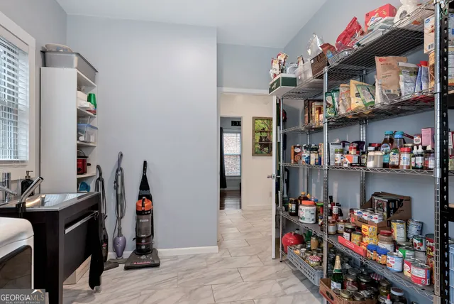 a workspace with furniture bookshelf and a window