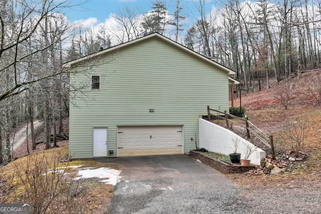 a backyard of a house with a large tree