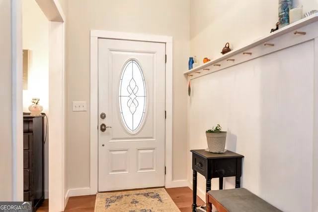 a view of a hallway with entryway wooden floor and front door
