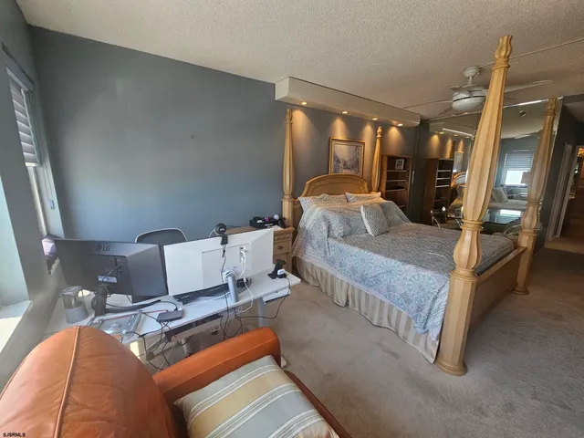 a bathroom with a granite countertop toilet and a sink