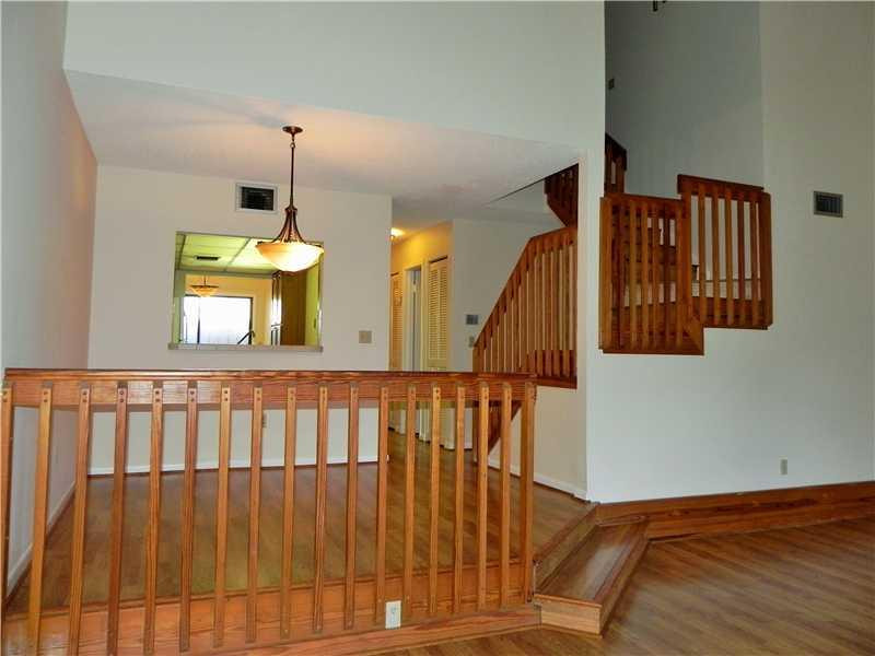 4183 Southwest 87th Terrace, Unit 4183 Davie, FL 33328 - Photo 12 of 34 a view of staircase with railing and a chandelier
