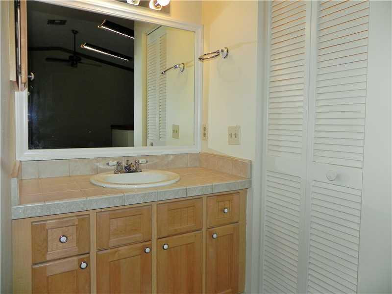 4183 Southwest 87th Terrace, Unit 4183 Davie, FL 33328 - Photo 22 of 34 a bathroom with a sink and a mirror