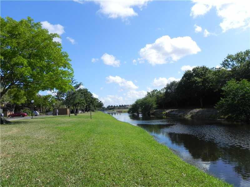 4183 Southwest 87th Terrace, Unit 4183 Davie, FL 33328 - Photo 27 of 34 a view of a golf course with a lake