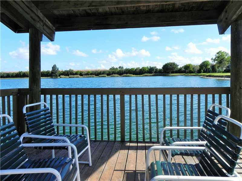 4183 Southwest 87th Terrace, Unit 4183 Davie, FL 33328 - Photo 31 of 34 a view of a balcony with wooden floor and outdoor seating