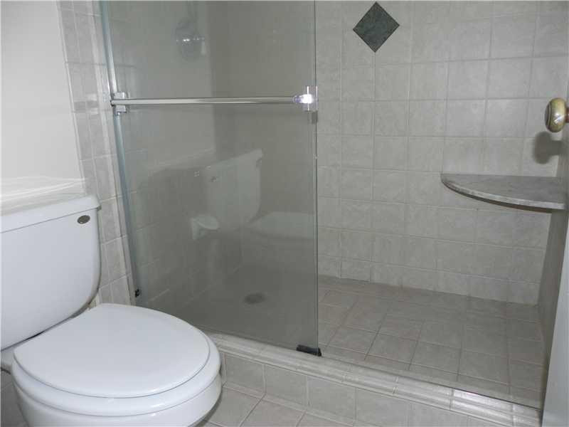 4183 Southwest 87th Terrace, Unit 4183 Davie, FL 33328 - Photo 6 of 34 a white toilet next to a bathroom sink