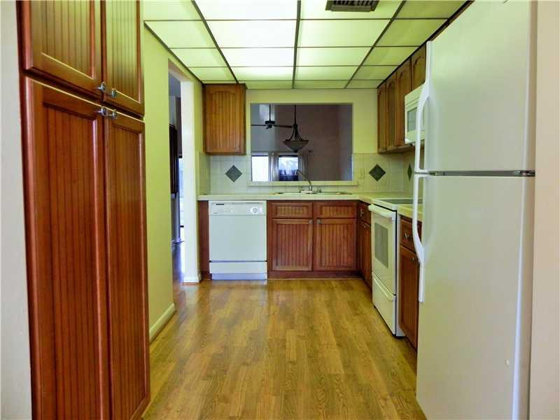 4183 Southwest 87th Terrace, Unit 4183 Davie, FL 33328 - Photo 9 of 34 a kitchen with stainless steel appliances granite countertop a refrigerator a sink and dishwasher