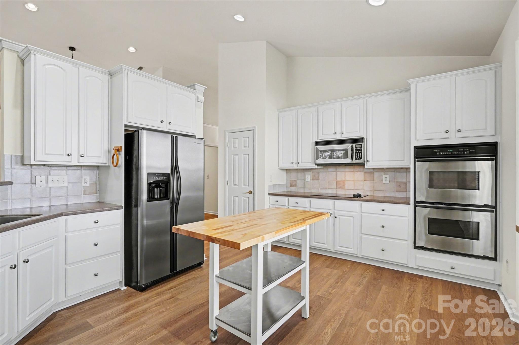 977 Platinum Drive Fort Mill, SC 29708 - Photo 13 of 41 a kitchen with granite countertop white cabinets and stainless steel appliances