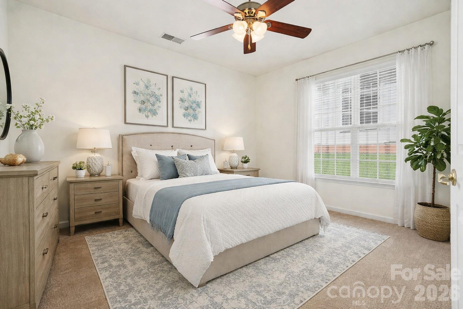 977 Platinum Drive Fort Mill, SC 29708 - Photo 18 of 41 a bedroom with a large bed and a chandelier