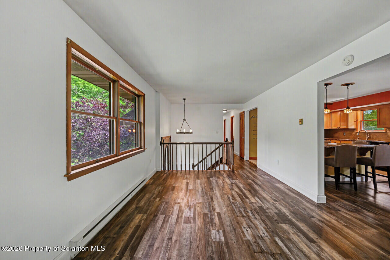 211 Buckingham Street Moscow, PA 18444 - Photo 19 of 83 a view of a hallway with wooden floor and furniture