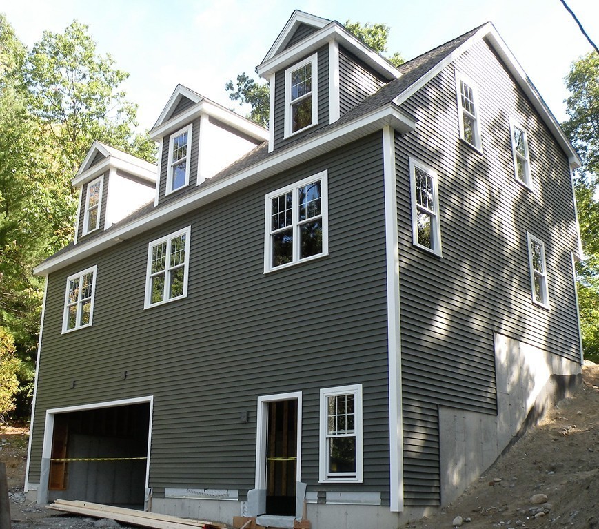 a view of a house with a yard and large windows