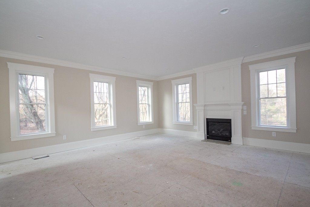 27 Birch Road Littleton, MA 01460 - Photo 11 of 22 an empty room with windows fireplace and windows