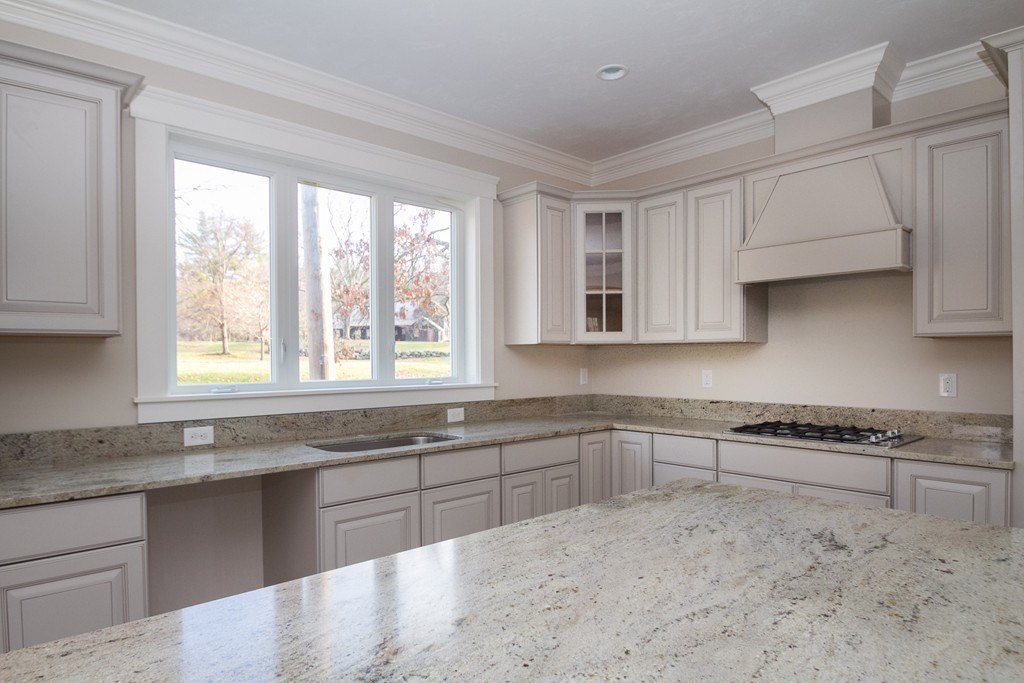 27 Birch Road Littleton, MA 01460 - Photo 13 of 22 a kitchen with stainless steel appliances granite countertop a sink and a stove