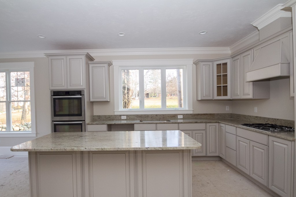 27 Birch Road Littleton, MA 01460 - Photo 15 of 22 a kitchen with granite countertop a stove a sink and a microwave