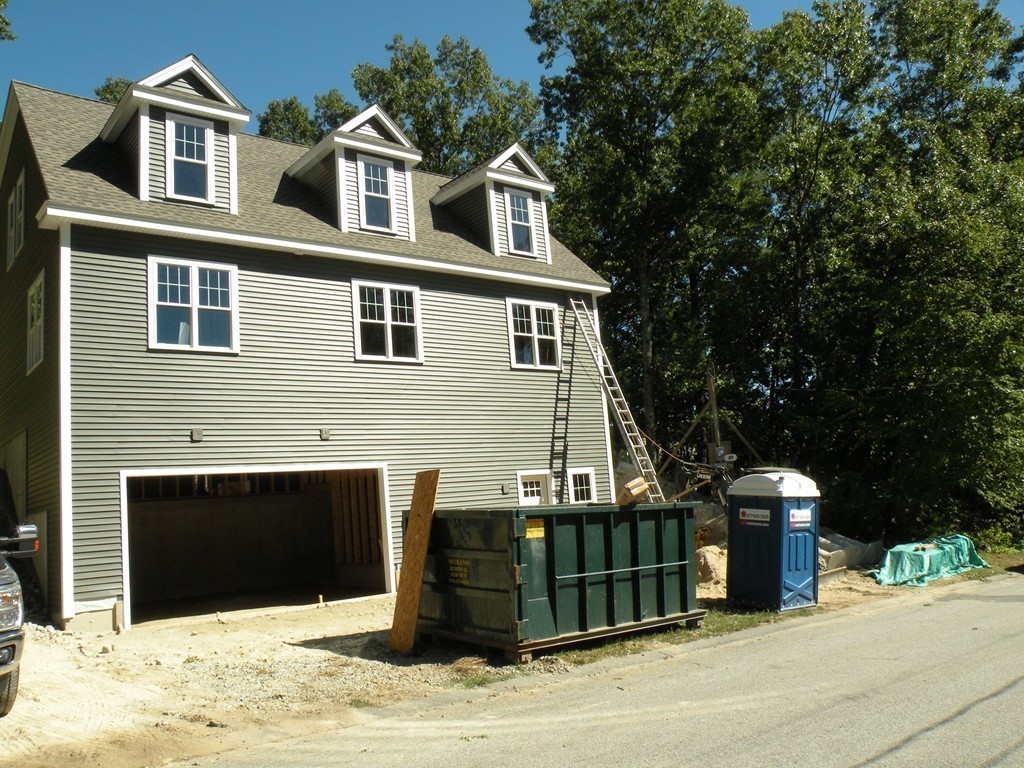 27 Birch Road Littleton, MA 01460 - Photo 2 of 22 a front view of a house with a garage