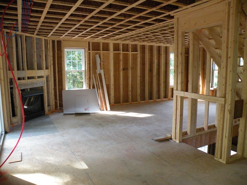 27 Birch Road Littleton, MA 01460 - Photo 3 of 22 a view of an empty room with a fireplace and a window