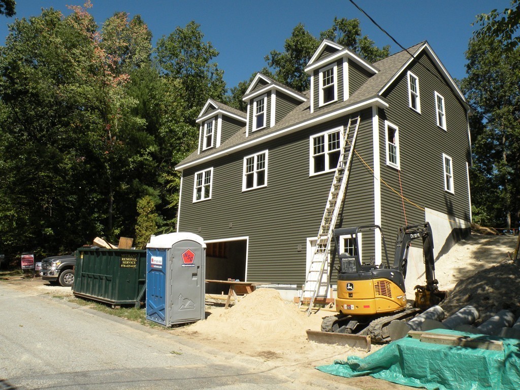 27 Birch Road Littleton, MA 01460 - Photo 4 of 22 a front view of a house with large trees and cars parked